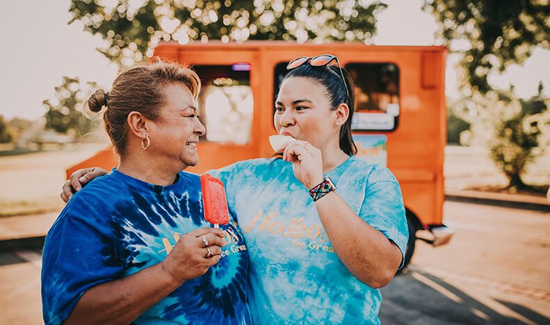 Two people enjoying popsicles ford family foundation grants
